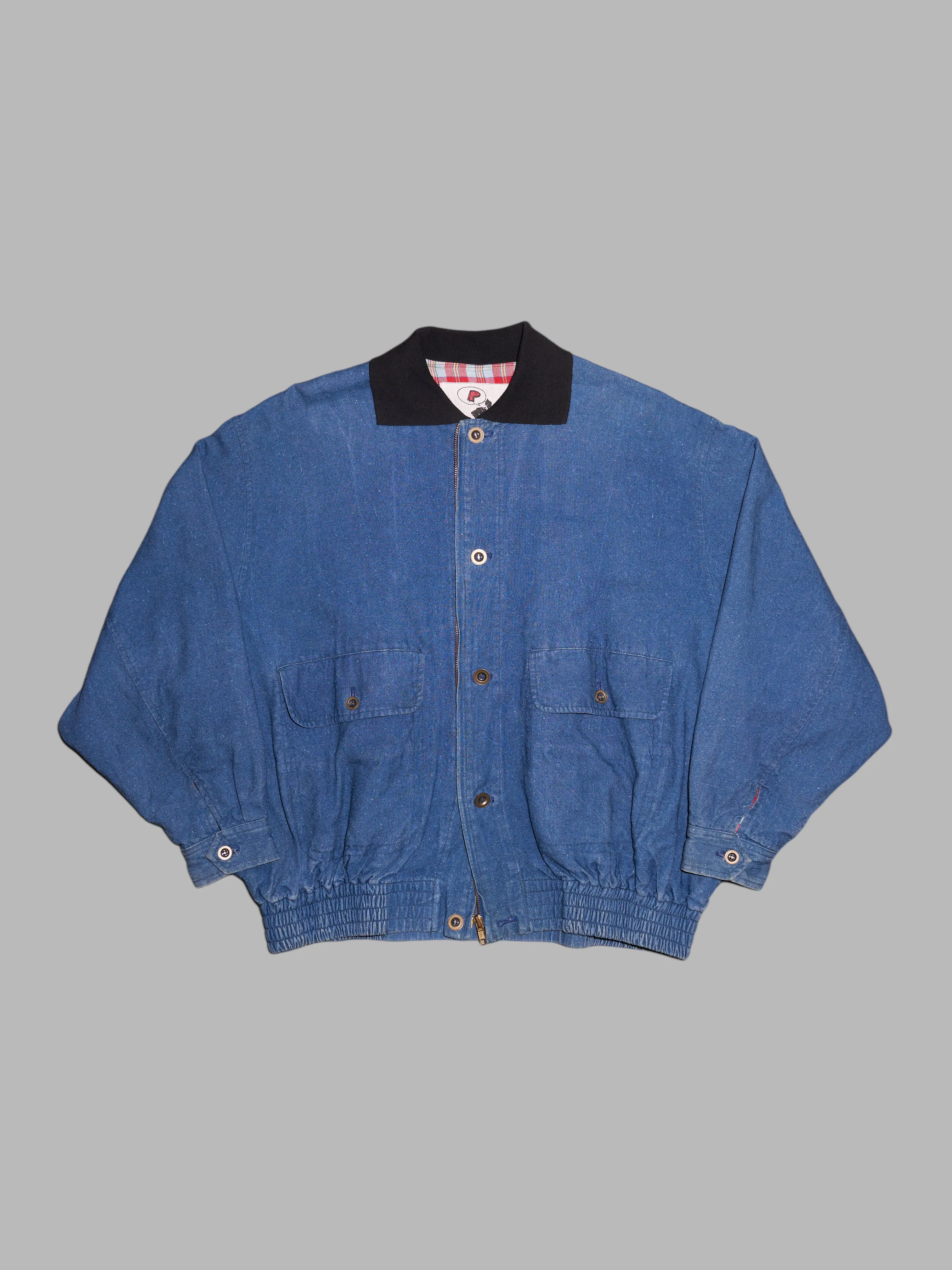 Person's 1980s indigo denim flannel lined bomber jacket