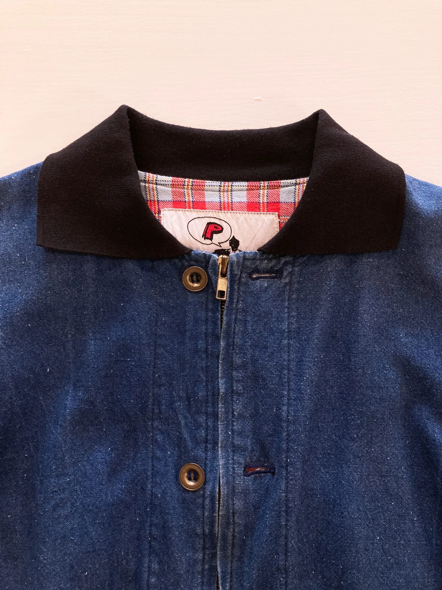 Person's 1980s indigo denim flannel lined bomber jacket